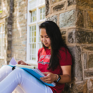 female student at saint joseph's university reading a book