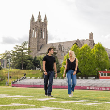 Two students walking on Sweeney Field on Saint Joseph's University's campus