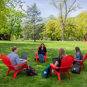 students learning outside with professor