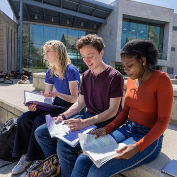 three saint joseph's university students studying outside