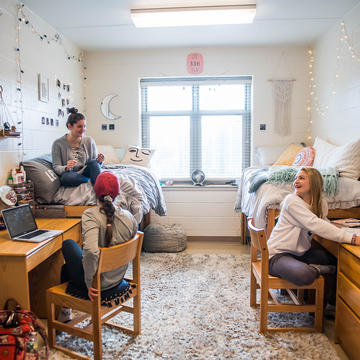Students talking in a dorm room on Saint Joseph's University's campus