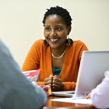 graduate student wearing an orange cardigan