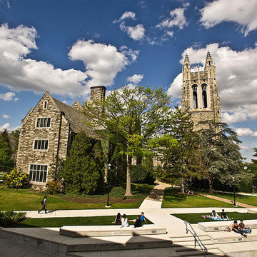 Barbelin Hall from Drexel Library with students relaxing in the grass.