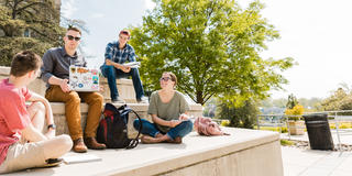 Saint Joseph's Students sitting on the steps out side the Drexel Library at Saint Joseph's University Campus