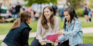 Students on campus lawn outside Villager Hall