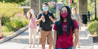 Students walking on Saint Joseph's University's campus wearing masks in the fall 2020 semester.