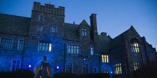 Barbelin Tower at Saint Joseph's University with blue light shining on it for Autism month.