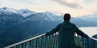 Student on a bridge looking out over the horizon