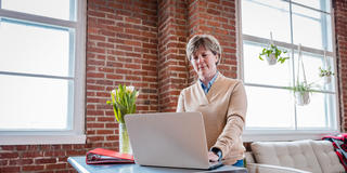 woman doing school work on her laptop at home