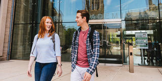 2 students walking outside the Drexel library on Saint Joseph's University campus