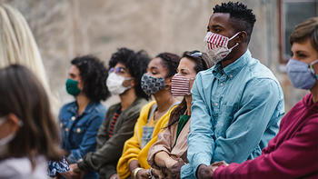 Group of people protesting on street holding hands