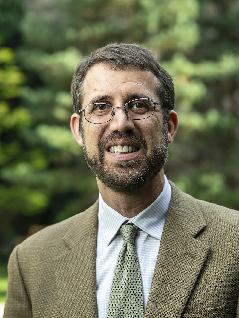 Adam Gregerman smiles in a suit