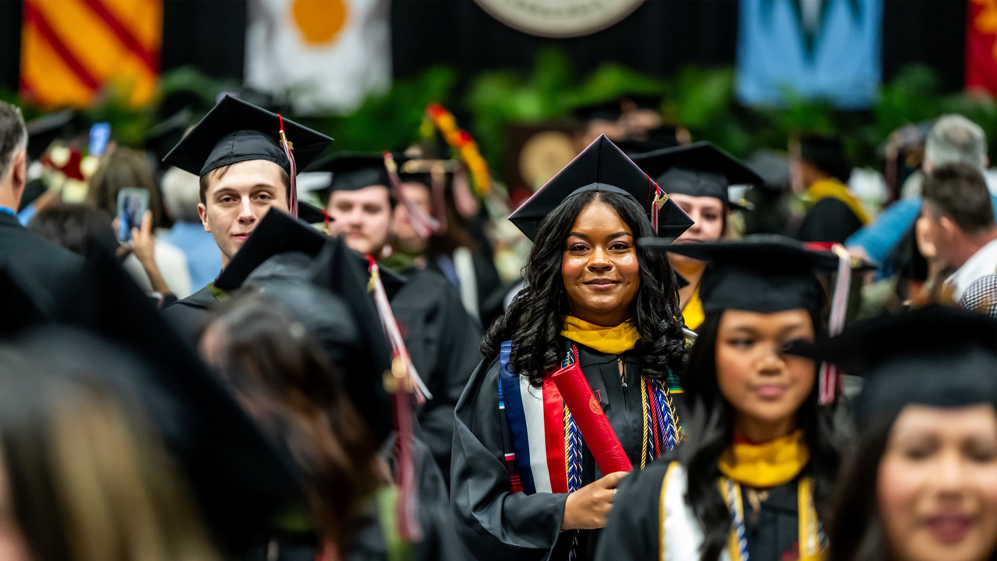 Students in regalia recessing from the graduation ceremony