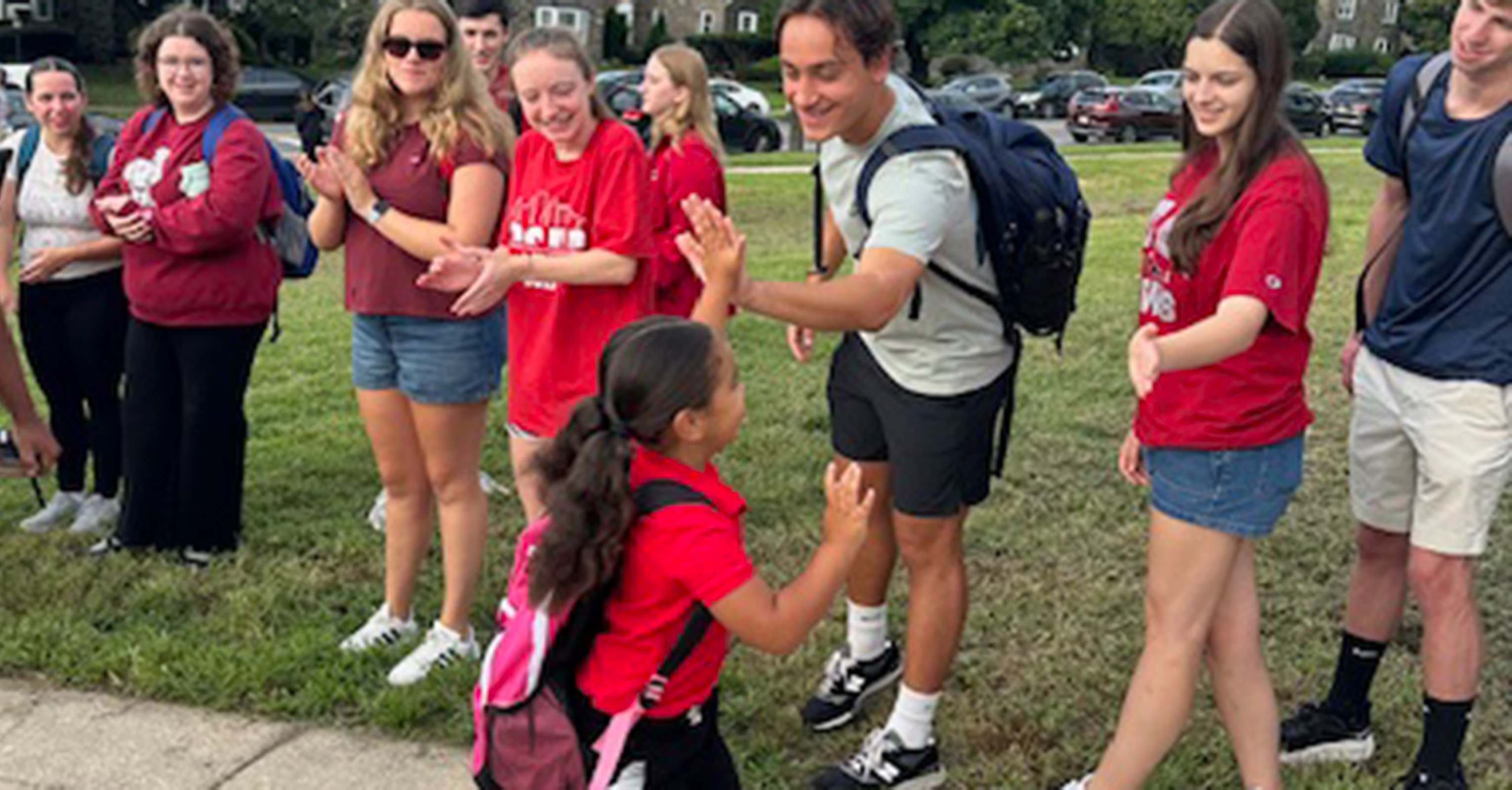 magic scholars high-fiving an elementary school student