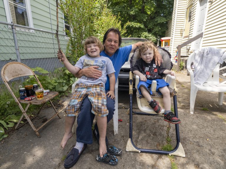 photograph of a father and his son and daughter