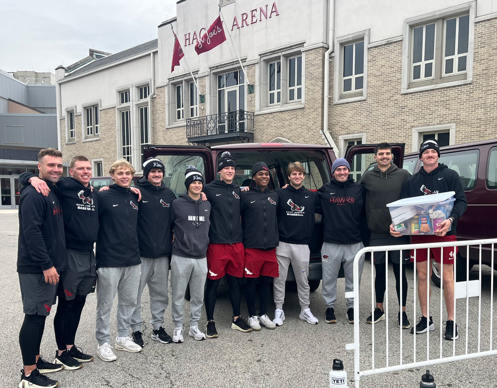 student volunteers with donated food for Thanksgiving