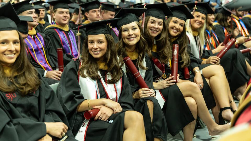 Students in regalia seated at commencement