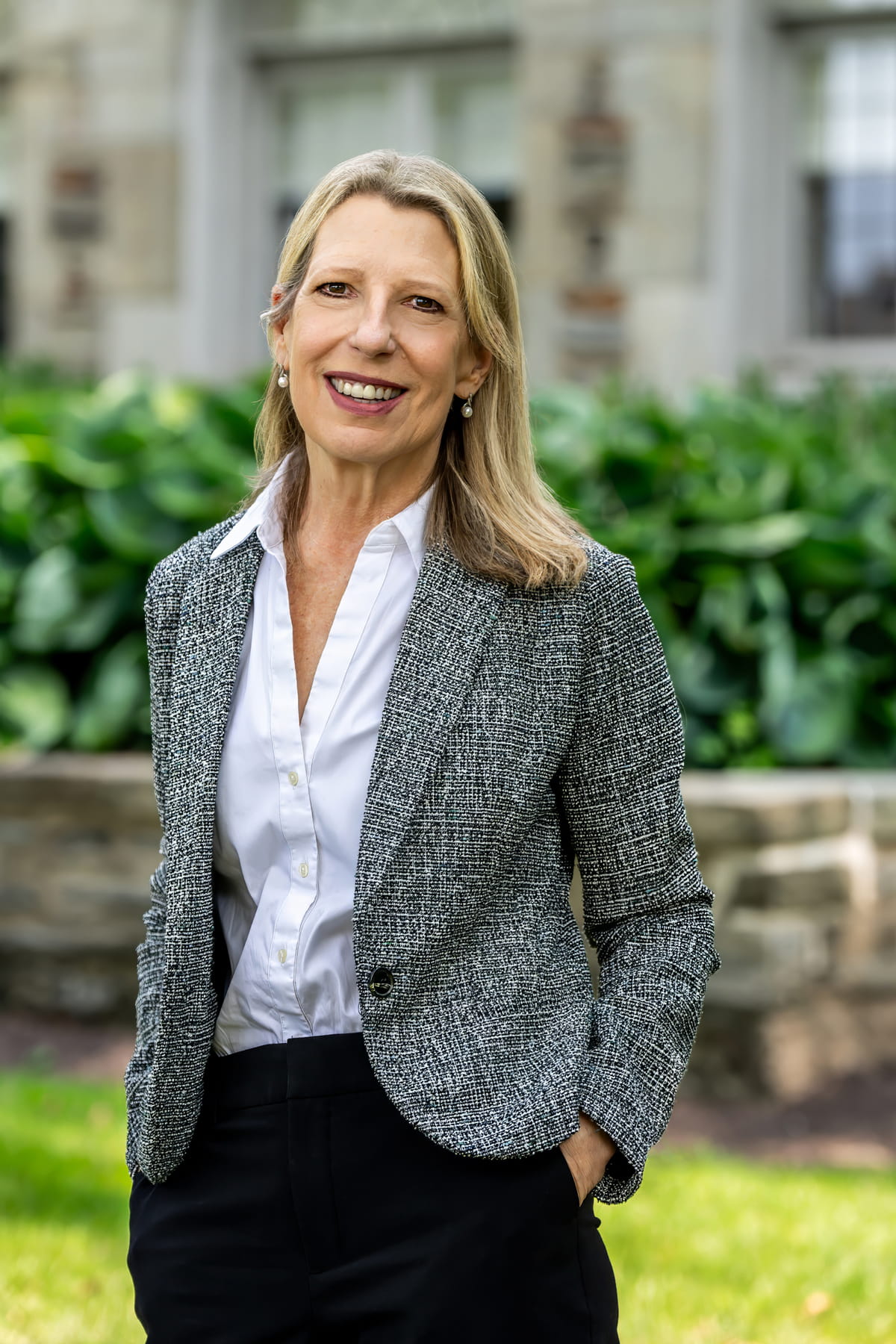 SJU President Cheryl Ann McConnell standing outside of Regis Hall