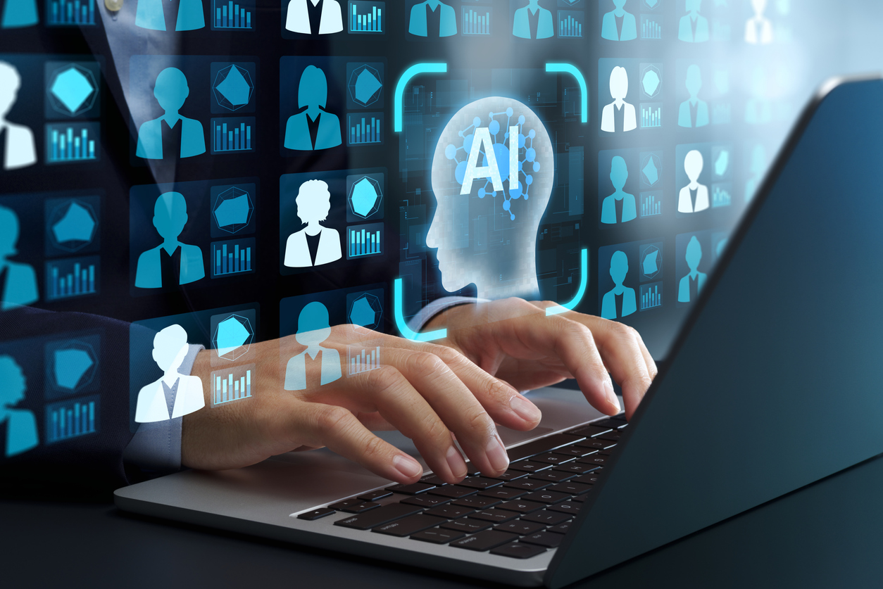 Hands at computer with the letters AI superimposed