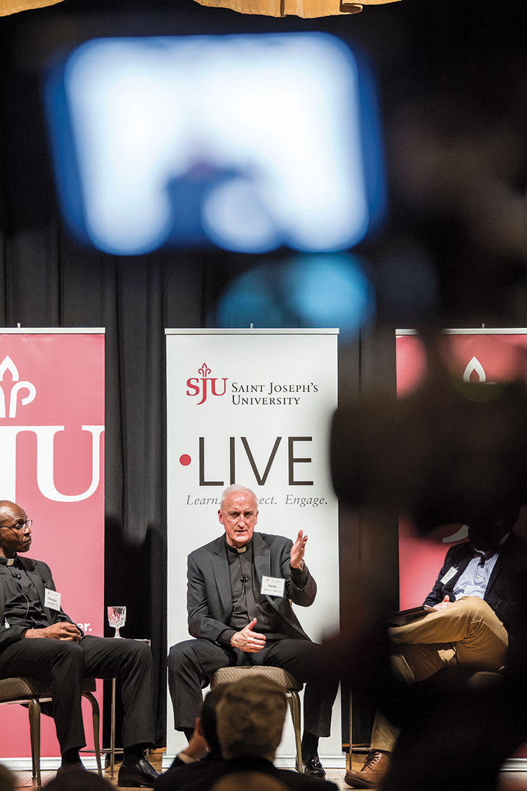 Fr. Clark presenting research at event