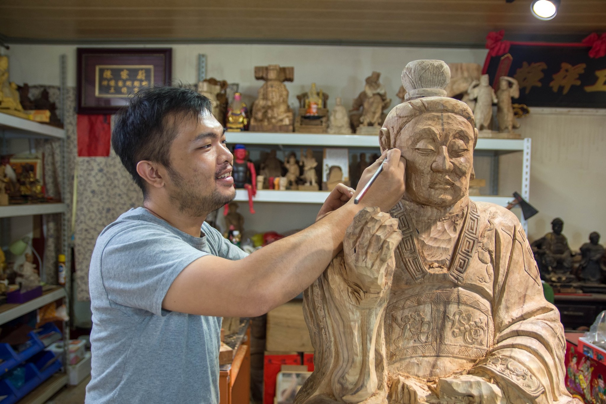 Chen Zongwei carves a large statue at his workshop in Lukang, Taiwan.