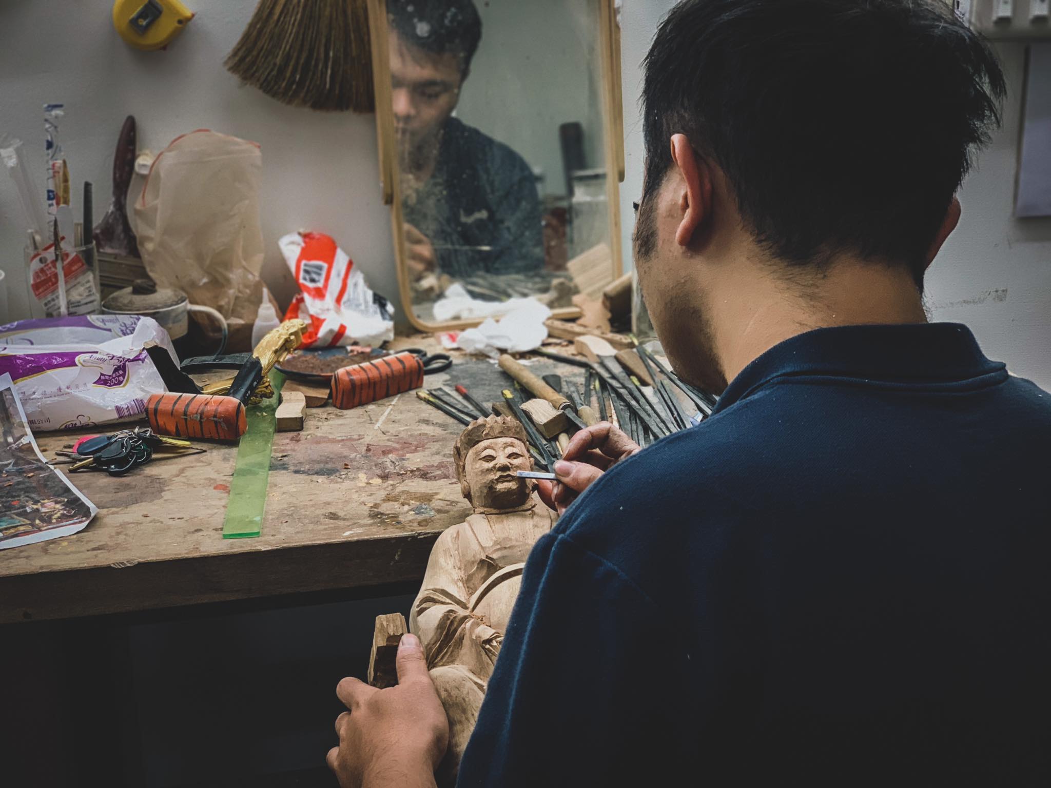 Chen Zongwei carves a statue at his studio in Lukang, Taiwan.