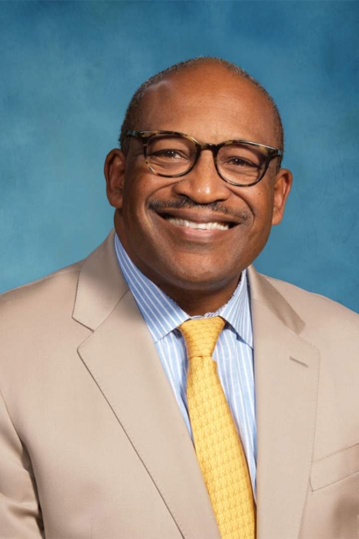 Headshot of Bryan Carter against a blue background