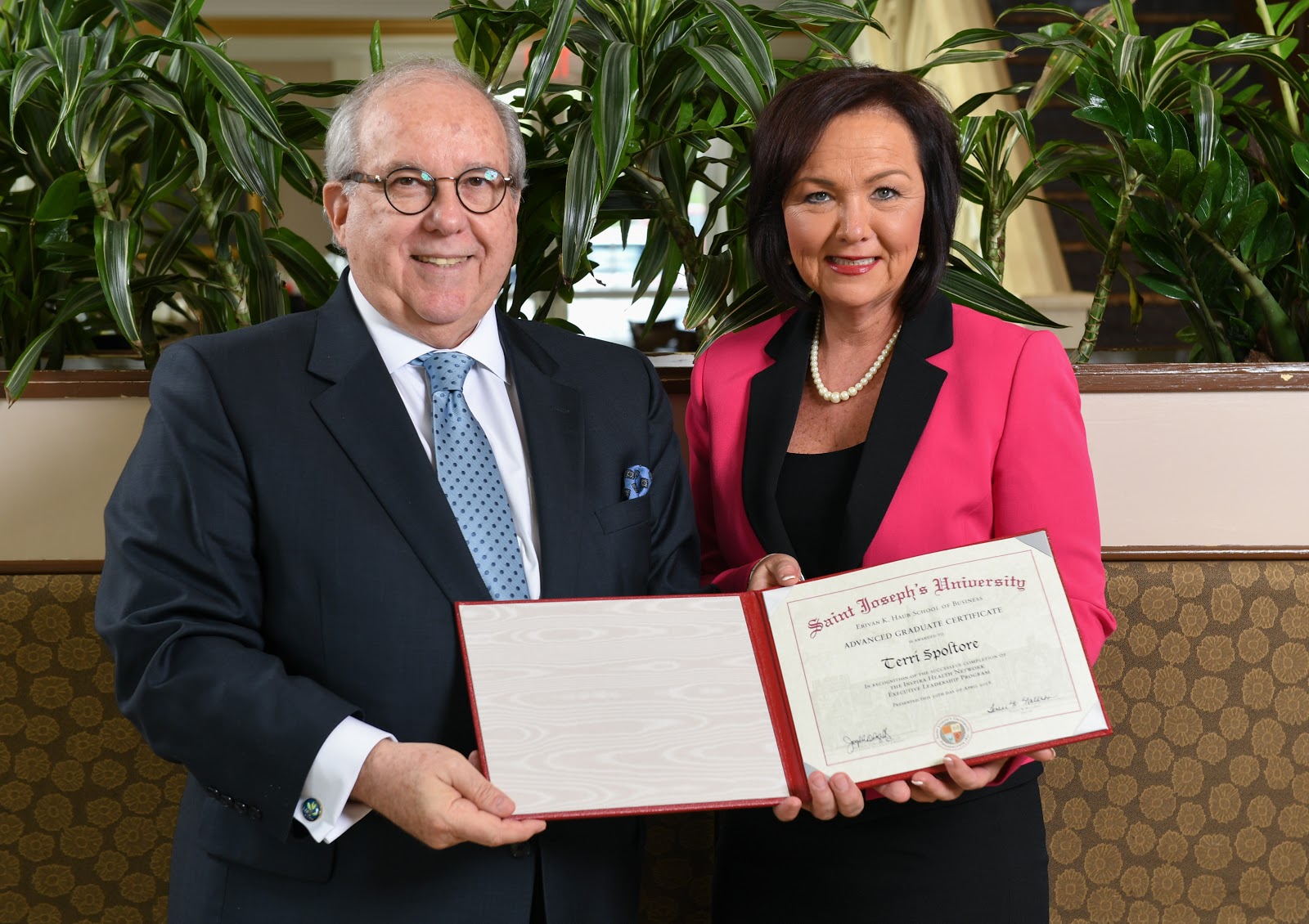 Spoltore receiving her certificate with Joseph A. DiAngelo '70, Ed.D., Dean of the Erivan K. Haub School of Business