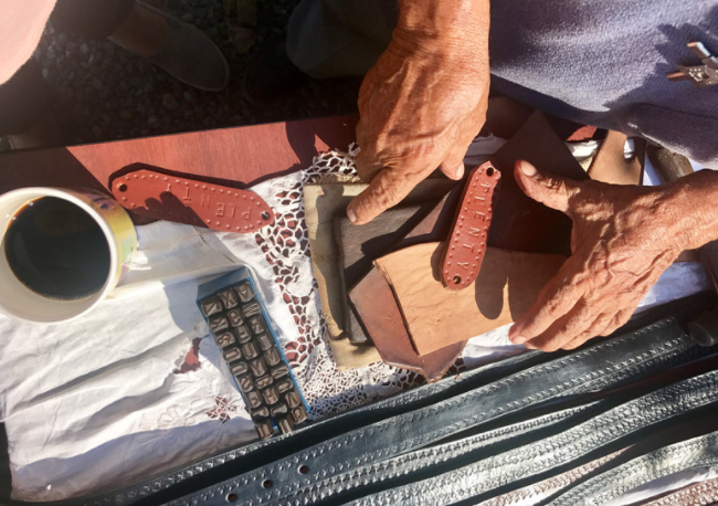 Hands working on creating leather products