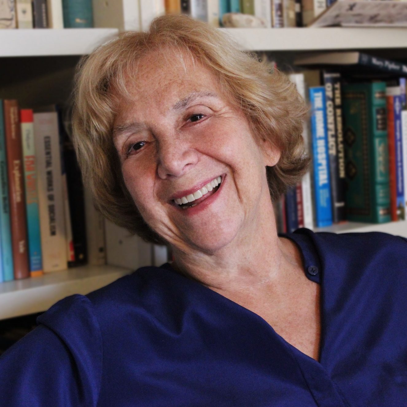 Jane Isay sitting in front of a book shelf