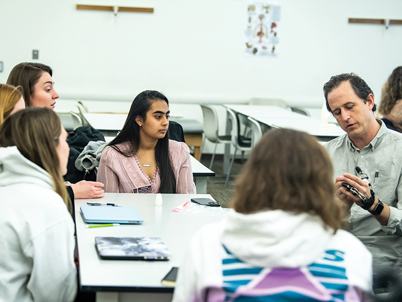 Josh Powers reviews prosthetic designs with SJU students