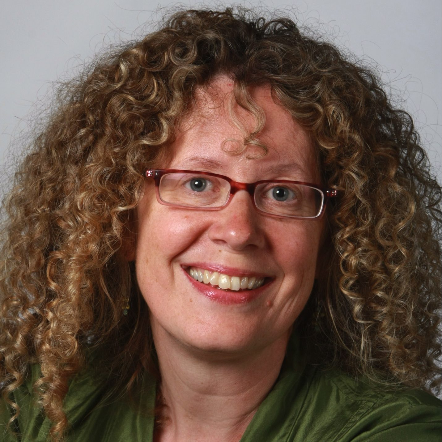 Laurie Hertzel, woman with curly hair and glasses