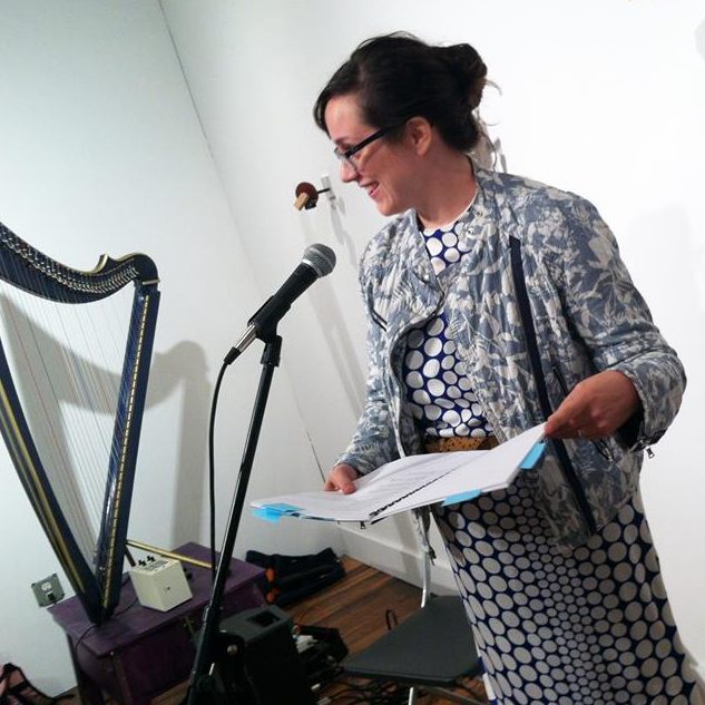 Meghan Dahn reading in front of a mic