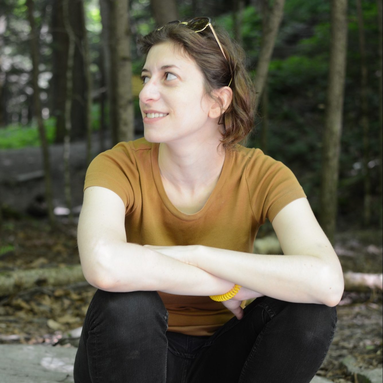 Michele Hirsch wearing yellow shirt and sitting outside 