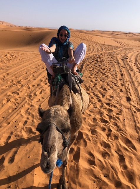 girl riding a camel in morocco