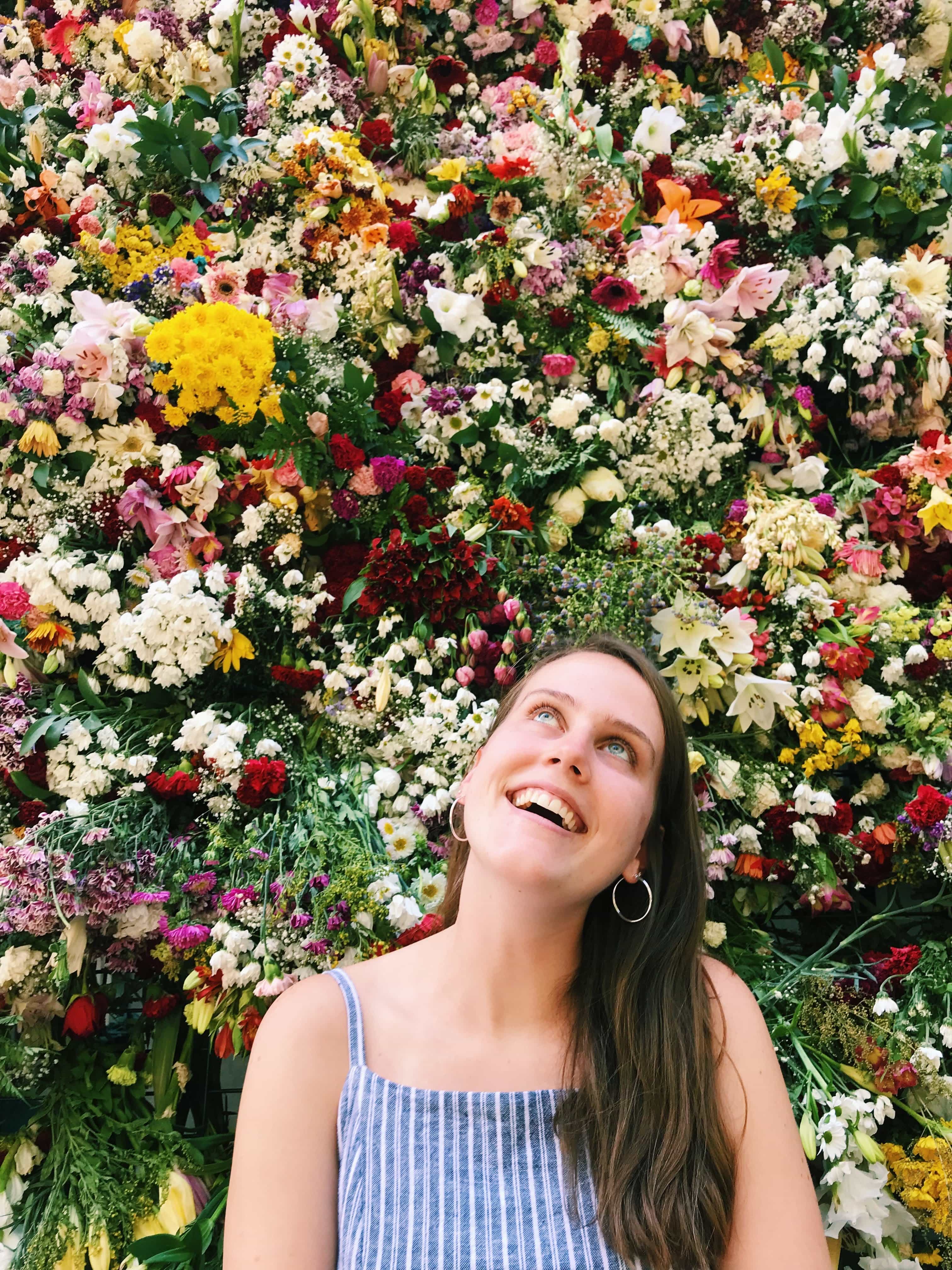 girl posing in front of flowers