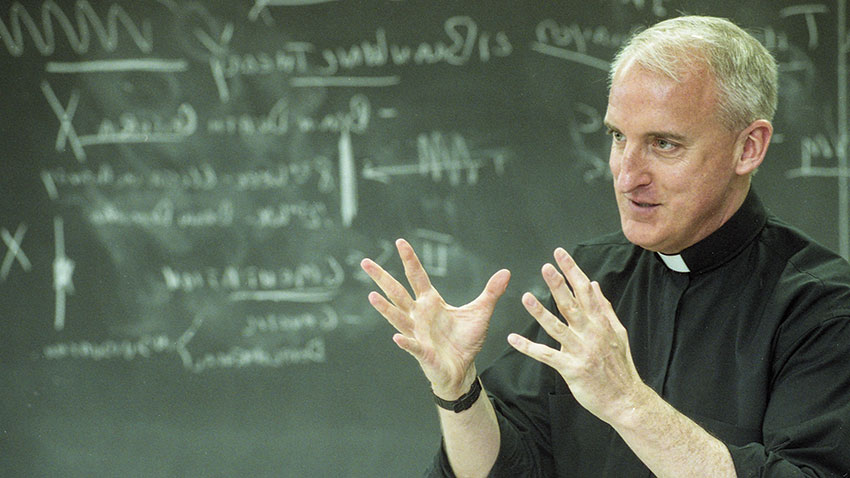 Fr. Clark teaching in a classroom 