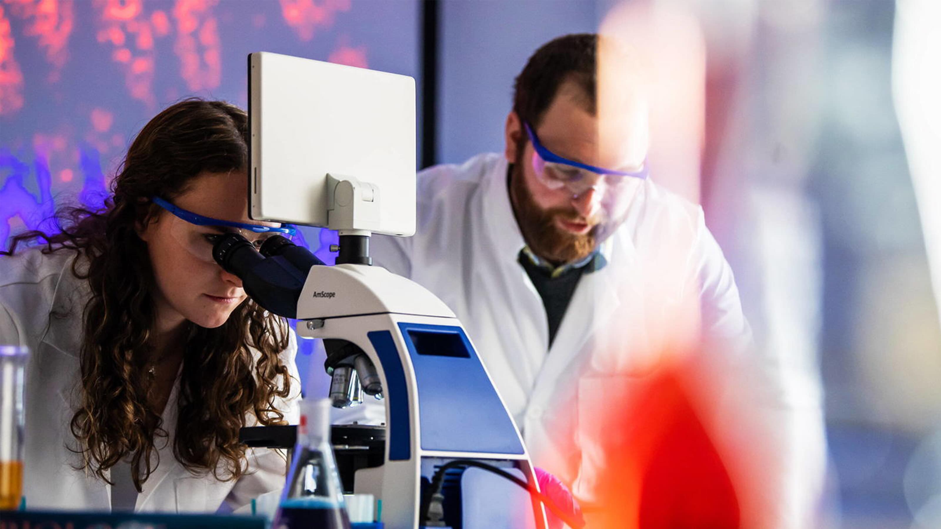 Students conducting research at a microscope