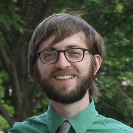 Dan Wisniewski wearing a green shirt and glasses