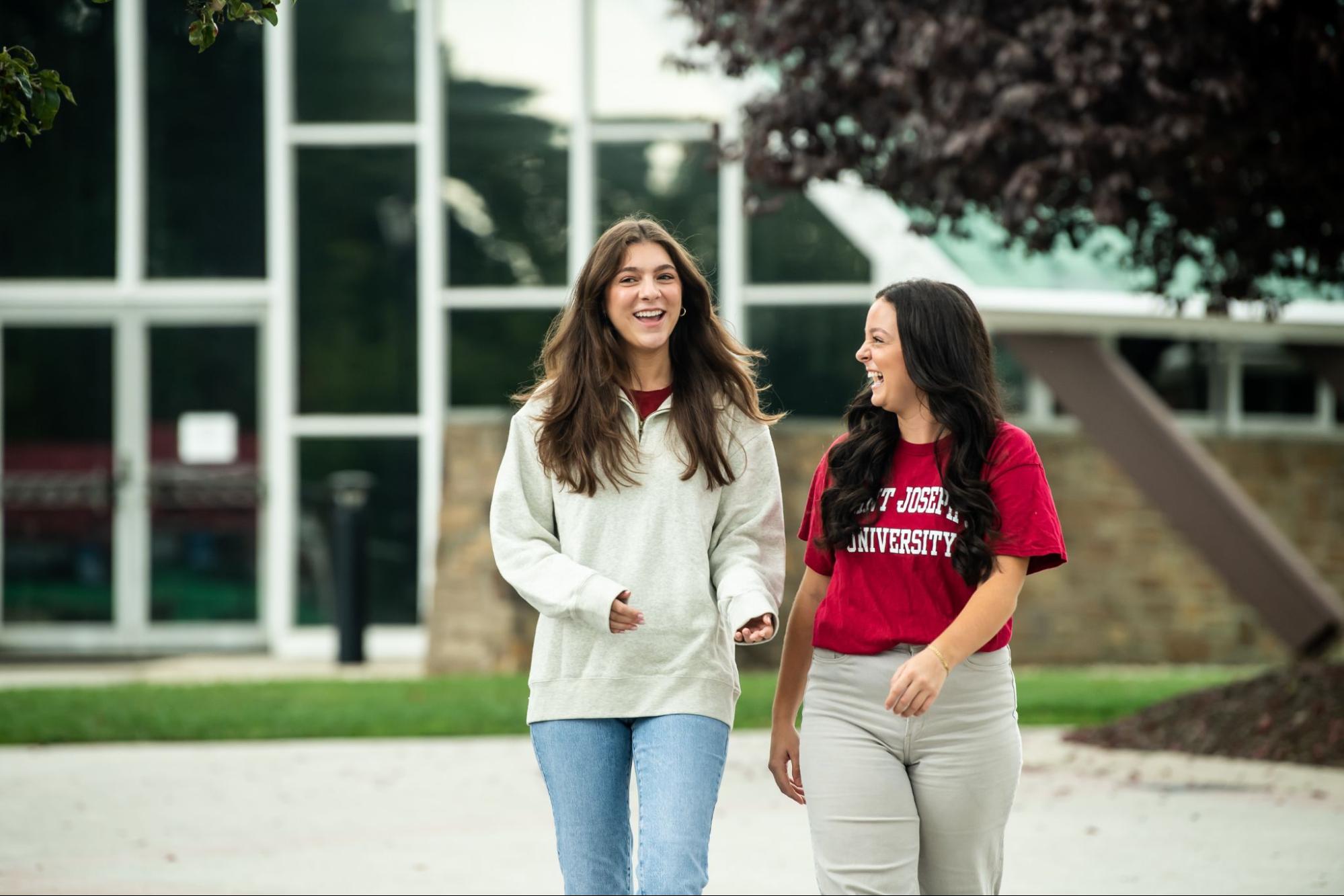 Two female students walking on Saint Joseph's campus