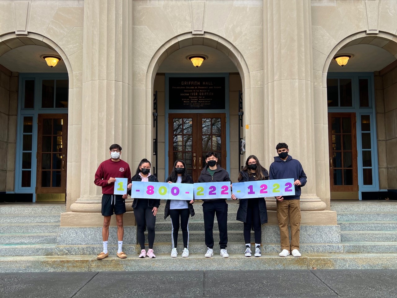 Students in the Operation OTC Medical Safety group hold signs spelling out 1-800-222-1222, the phone number for the posion control hotline