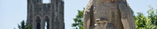 The hawk statue with barbelin tower behind it