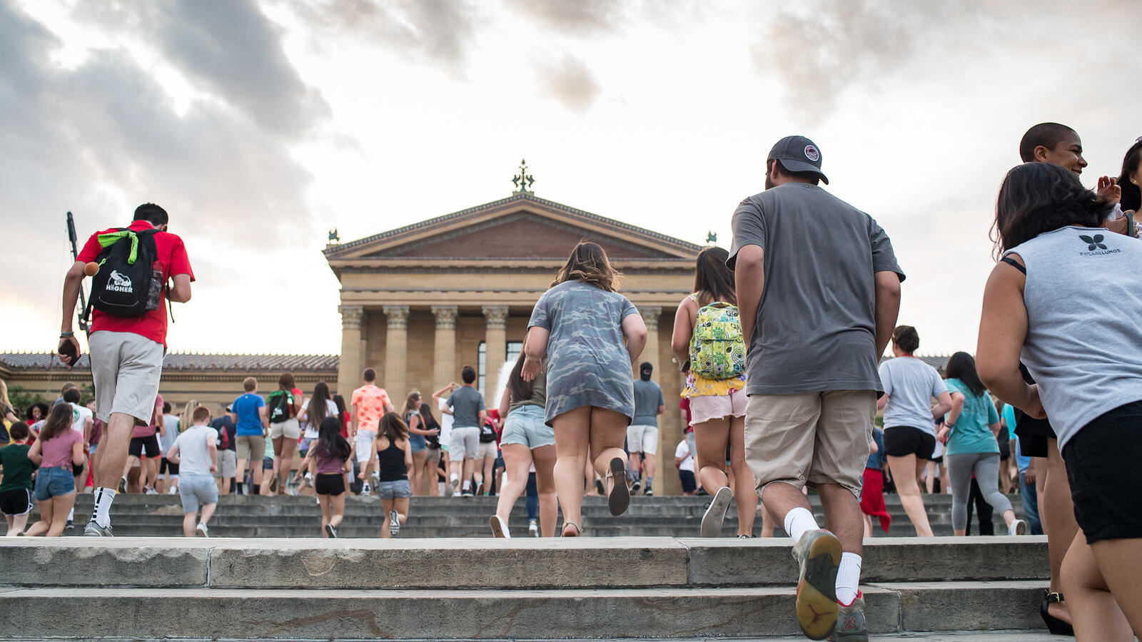 People running up the steps of the Philadelphia Art Musem