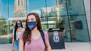 Saint Joseph's students walking outside the Drexel Library with masks.