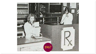 Old photo of Usciences students in a mock pharmacy