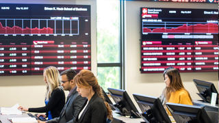 Students sit in Wall Street Trading Room.