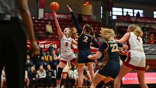 Four players on the basketball court during the SJU-Drexel women's basketball team
