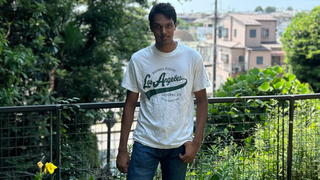 Photo of senior summer scholar Samuel Vizzeswarapu standing outside