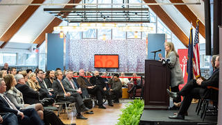 Dr. McConnell, President of Saint Joseph's University at a podium in the Foley Center