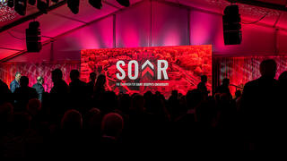 Gallery for the launch of SOAR: capital campaign for Saint Joseph's University with a large gathering of people in a ballroom.